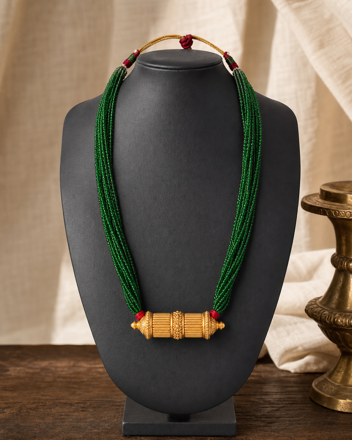 Maili Tilhari with green glass potey strands and a gold-plated fluted cylinder