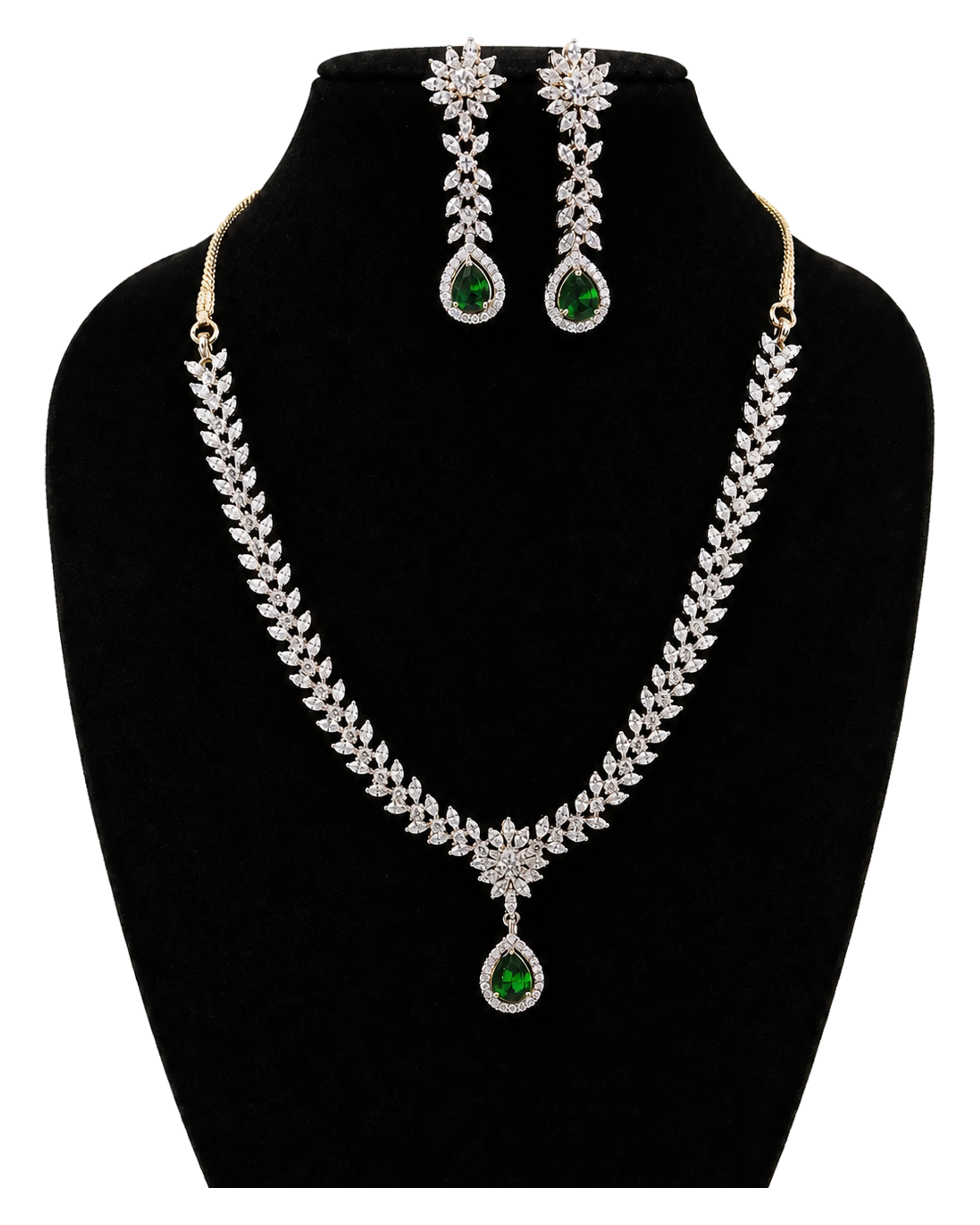 A silver-tone haar necklace with green teardrop accents, leaf-shaped sparkle and matching earrings.